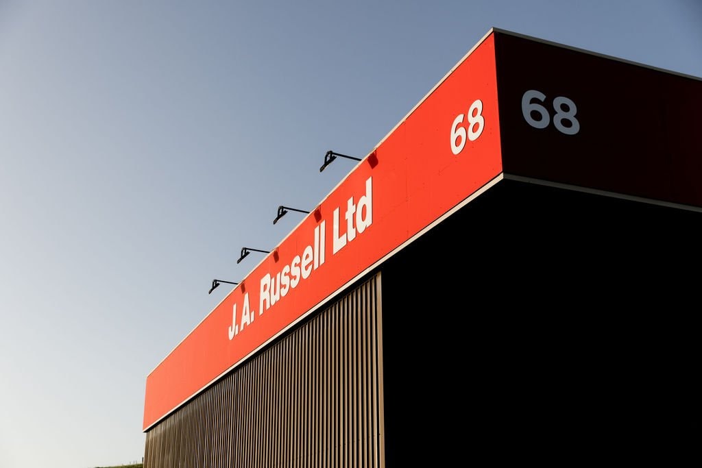 J.A. Russell branded frontage on a dark-clad trade building