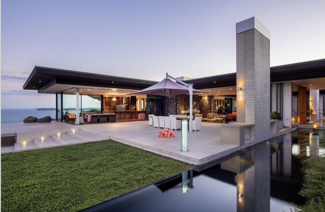 The Mahurangi Peninsula home and terrace at dusk